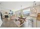 Open layout with a fireplace, cozy seating area, eat-in kitchen, and seamless access to the outdoors at 1985 Firenza Dr, Apex, NC 27502
