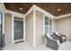 Inviting front porch features seating and a beautifully decorated front door at 1985 Firenza Dr, Apex, NC 27502