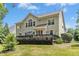 Home's backyard with a tiered deck and lawn at 203 Pathwood Ln, Durham, NC 27705