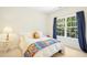 Bright bedroom with a comfortable bed, natural light from a large window, and colorful accents at 203 Pathwood Ln, Durham, NC 27705