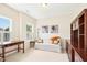 Bonus room with a comfortable sofa, desk, and ample natural light, creating a versatile space at 203 Pathwood Ln, Durham, NC 27705