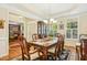 Formal dining room with a tray ceiling, chandelier, and views into adjacent rooms at 203 Pathwood Ln, Durham, NC 27705