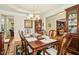 Beautiful dining room with a wood table, chandelier, and views into other living areas at 203 Pathwood Ln, Durham, NC 27705
