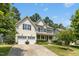 Traditional two-story home with a well-manicured lawn and mature trees at 203 Pathwood Ln, Durham, NC 27705