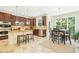 A spacious kitchen offers dark wood cabinets, stainless appliances, and an island with stool seating at 203 Pathwood Ln, Durham, NC 27705