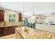 Bright eat-in kitchen featuring an island with seating and stainless steel appliances at 203 Pathwood Ln, Durham, NC 27705