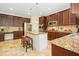 Spacious kitchen features granite counters, an island with seating, and stainless steel appliances at 203 Pathwood Ln, Durham, NC 27705