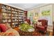 Cozy library with built-in bookshelves, comfortable seating, and ample natural light from bright windows at 203 Pathwood Ln, Durham, NC 27705