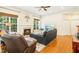 Cozy living room featuring a fireplace, comfortable leather seating, and a ceiling fan at 203 Pathwood Ln, Durham, NC 27705