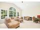 Spacious living room with large windows and comfortable seating at 203 Pathwood Ln, Durham, NC 27705
