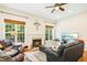 Bright living room with a fireplace, comfortable seating, and natural light from large windows at 203 Pathwood Ln, Durham, NC 27705
