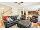 Spacious living room with hardwood floors, comfortable seating, and seamless connection to the kitchen at 203 Pathwood Ln, Durham, NC 27705
