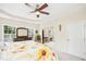 Bright main bedroom with tray ceilings, plenty of windows, and a view into an attached sitting area at 203 Pathwood Ln, Durham, NC 27705