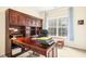 Executive office featuring a large wooden desk with ample storage, natural light, and neutral decor at 203 Pathwood Ln, Durham, NC 27705