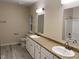 The bathroom has a double vanity, toilet, towel bars, and tub with shower at 206 E Silver Belle Dr, Zebulon, NC 27597