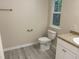 Bright bathroom features a vanity, toilet, towel rack, and natural light at 206 E Silver Belle Dr, Zebulon, NC 27597