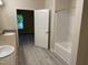 Bathroom featuring double vanity, shower and tub combo, and window to outside at 206 E Silver Belle Dr, Zebulon, NC 27597