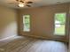 This bright bedroom has a ceiling fan and two windows to allow for plenty of natural light at 206 E Silver Belle Dr, Zebulon, NC 27597