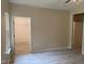 View of the bedroom and closet featuring wood-look flooring, ceiling fan, and neutral paint at 206 E Silver Belle Dr, Zebulon, NC 27597