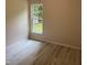 Bedroom featuring neutral walls, laminate flooring, and bright window at 206 E Silver Belle Dr, Zebulon, NC 27597