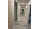 Long hallway with multiple doors and light-colored wood-look floors at 206 E Silver Belle Dr, Zebulon, NC 27597