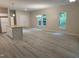 Open-concept living and kitchen area with white cabinets, stainless steel appliances, and an island at 206 E Silver Belle Dr, Zebulon, NC 27597