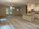 Open kitchen with island, white cabinets, granite countertops, and stainless steel appliances at 206 E Silver Belle Dr, Zebulon, NC 27597