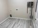 Laundry room with updated tankless water heater and new flooring at 206 E Silver Belle Dr, Zebulon, NC 27597