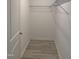 This walk-in closet features wood-look flooring, white walls, and wire shelving at 206 E Silver Belle Dr, Zebulon, NC 27597