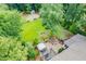 Aerial view showing the backyard featuring a paver patio, fire pit, outdoor kitchen, and sports court at 218 Inwood Forest Dr, Raleigh, NC 27603