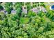 Lush backyard with green lawn and mature trees, providing privacy and a serene setting at 218 Inwood Forest Dr, Raleigh, NC 27603