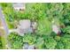 Aerial view showing landscaped lot with outdoor living area featuring patio, firepit, and sport court at 218 Inwood Forest Dr, Raleigh, NC 27603