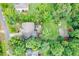 Private backyard featuring a lush lawn, mature trees, and a beautiful patio area for outdoor entertaining at 218 Inwood Forest Dr, Raleigh, NC 27603