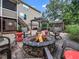 Inviting backyard with stone firepit and comfortable lounge furniture, ideal for entertaining at 218 Inwood Forest Dr, Raleigh, NC 27603
