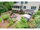 Spacious backyard with a covered porch, an outdoor kitchen, a fireplace, and mature trees for privacy at 218 Inwood Forest Dr, Raleigh, NC 27603