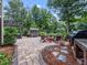 Outdoor living space with fire pit, hot tub, grill area and seating at 218 Inwood Forest Dr, Raleigh, NC 27603