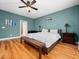 Bright primary bedroom featuring hardwood flooring and blue accent wall at 218 Inwood Forest Dr, Raleigh, NC 27603