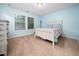 Serene bedroom with soft blue walls, natural light, and a charming white bed frame at 218 Inwood Forest Dr, Raleigh, NC 27603