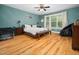 Bright bedroom with hardwood floors, fan, large window and king bed at 218 Inwood Forest Dr, Raleigh, NC 27603