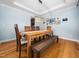 Dining room featuring modern light fixture, wooden table, and hardwood floors at 218 Inwood Forest Dr, Raleigh, NC 27603