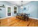 Dining room with hardwood floors, modern light fixture and views to a porch at 218 Inwood Forest Dr, Raleigh, NC 27603
