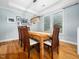 Dining room featuring wood table, natural lighting, and modern light fixture at 218 Inwood Forest Dr, Raleigh, NC 27603