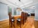 Dining room with wooden table, pendant lighting, and adjacent to living space at 218 Inwood Forest Dr, Raleigh, NC 27603
