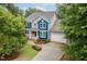 Attractive two-story home with a blue and gray exterior, manicured landscaping, and an attached garage at 218 Inwood Forest Dr, Raleigh, NC 27603