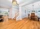 Bright foyer featuring hardwood floors, staircase, and open access to the dining room at 218 Inwood Forest Dr, Raleigh, NC 27603