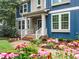 Charming front porch with decorative plants and flowers adding curb appeal at 218 Inwood Forest Dr, Raleigh, NC 27603