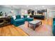 Open concept living room and kitchen with hardwood floors and a blue sectional sofa at 218 Inwood Forest Dr, Raleigh, NC 27603