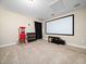 Well-lit carpeted media room with a large projection screen, popcorn machine, and neutral walls at 218 Inwood Forest Dr, Raleigh, NC 27603