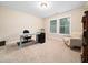 Bright office with a work desk, comfortable armchair, and ample natural light from the window at 218 Inwood Forest Dr, Raleigh, NC 27603