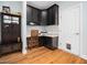 Home office nook with built-in desk, cabinets, and hardwood floors at 218 Inwood Forest Dr, Raleigh, NC 27603